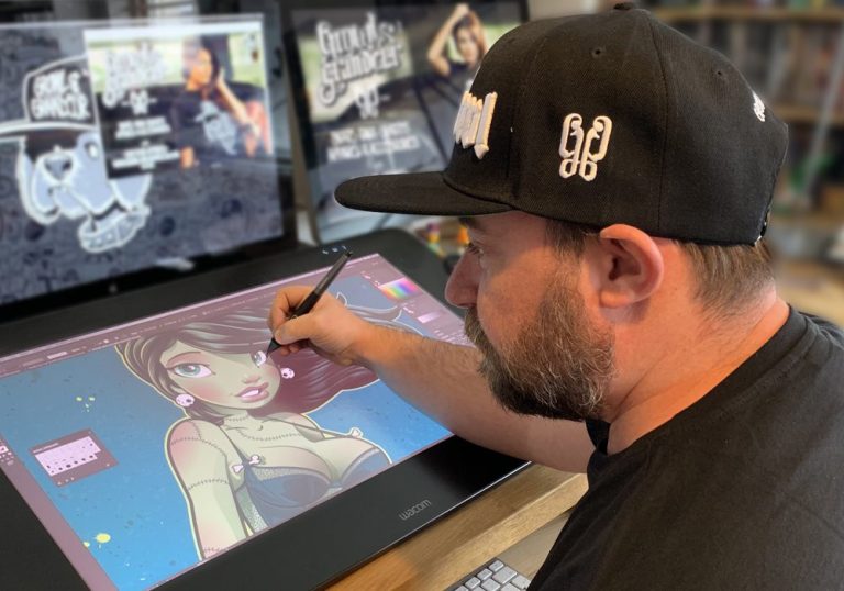 Colin ‘Choodie’ Hood: The Rise of Growl & Grandeur from London to Newquay Colin ‘Choodie’ Hood in his Newquay studio, surrounded by Growl & Grandeur apparel, embodying the brand's creative and rebellious spirit.