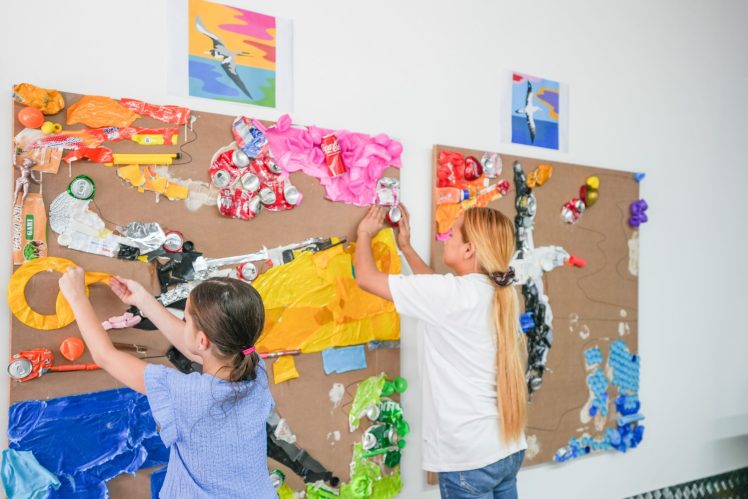 Dubai Unveils Recycled Plastic Mural for Plastic Free July at The Sustainable City Recycled plastic mural in Dubai's Sustainable City, created by residents and students for Plastic Free July, displayed on a community wall.