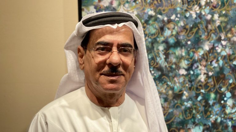 Mohammed Mandi: Master of Arabic Calligraphy and Cultural Heritage Mohammed Mandi creating intricate Arabic calligraphy with traditional tools.