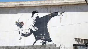 Street Art Revolutionaries: How Urban Murals are Shaping Social Discourse A vibrant mural on a city wall, featuring bold colors and powerful imagery depicting social issues, sparking conversation and activism.