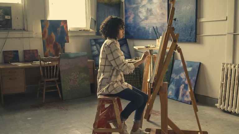 Beyond the Canvas: Unveiling the Unexpected Benefits of an Art Degree Art student painting on canvas, representing the diverse benefits of an art degree